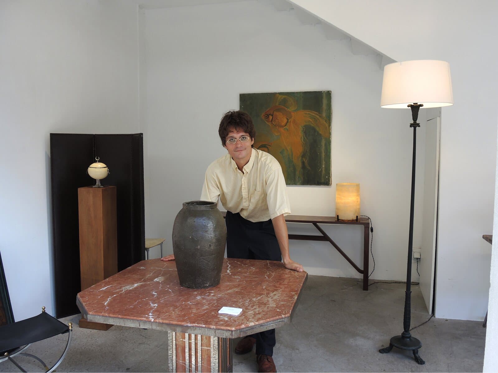 James Darle leaning on an octagonal marble table