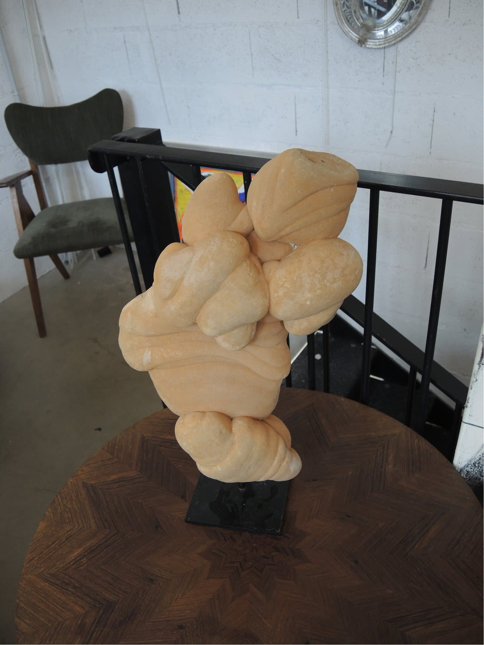 An organic stone sculpture on a round marquetry table